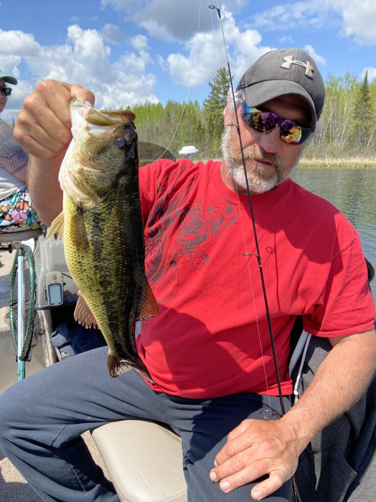 Justin Sparby catching fish on woman lake