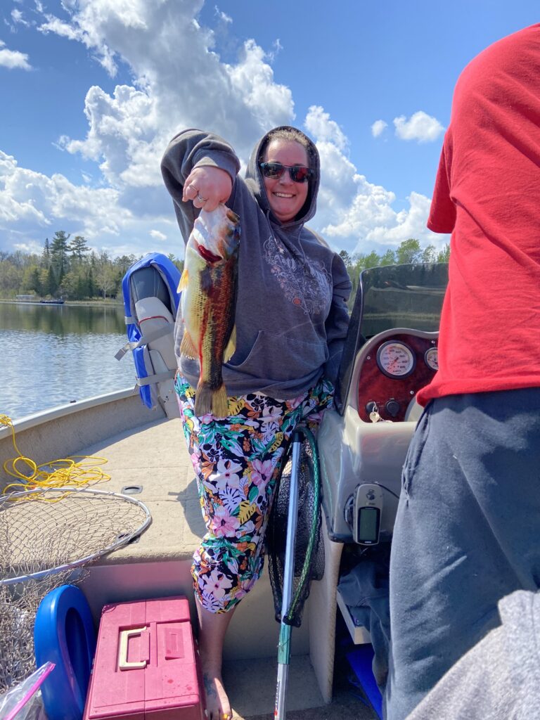 Kelly Sparby catching fish on woman lake