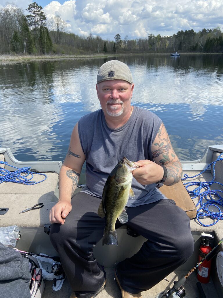 Richard Weberg catching fish on woman lake