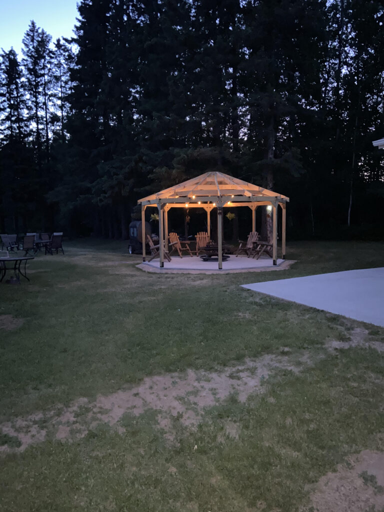 octagon gazebo with lights on at night